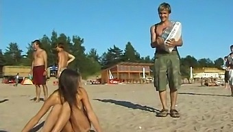 A Stunning Young Girl Enjoys A Nude Day At The Beach